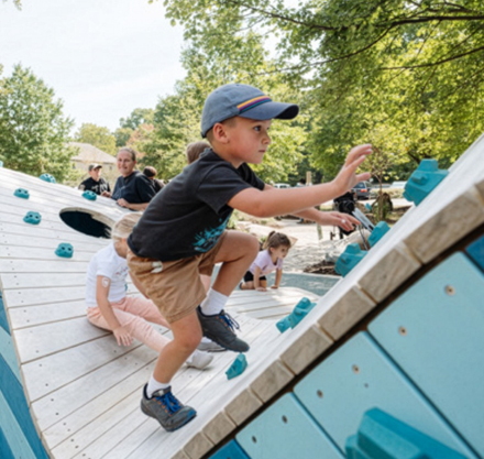 a boy on a blue and white playground